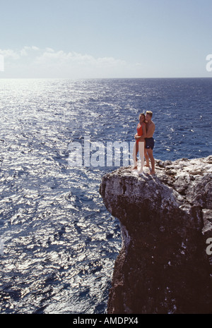 Grand Cayman couple on cliffs overlooking ocean Stock Photo