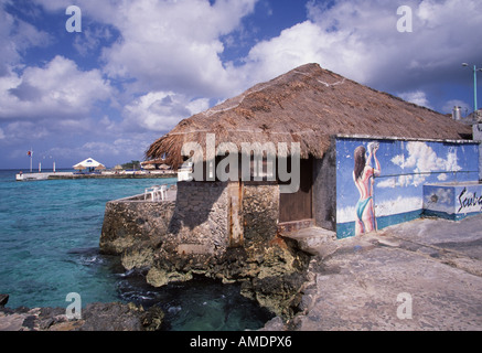 Mexico Cozumel Painted wall at Scuba Shack coast line in background Stock Photo