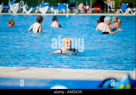 Spanish pensioners in the sunshine resort of Islantilla in the south of the country enjoying time ina swimming pool cb4w9585 Stock Photo