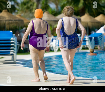 Spanish pensioners in the sunshine resort of Islantilla in the south of the country enjoying time ina swimming pool Stock Photo