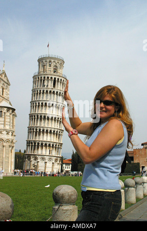 A woman supporting the leaning tower of Pisa Campo dei Miracoli Pisa Tuscany Italy 2004 Stock Photo