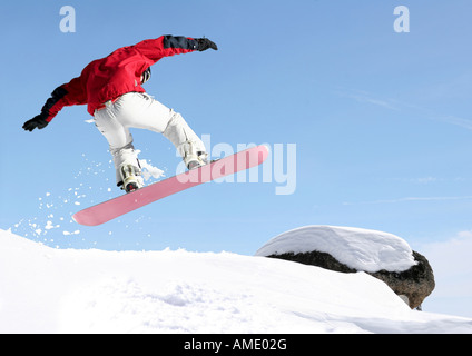 Snowboarder jumping high in the air Stock Photo