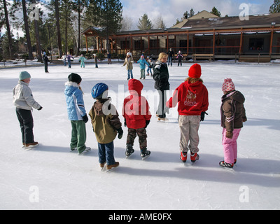 USA OREGON BEND A group of young children take their first ice skating lesson at an ice rink at Seventh Mountain Inn Stock Photo