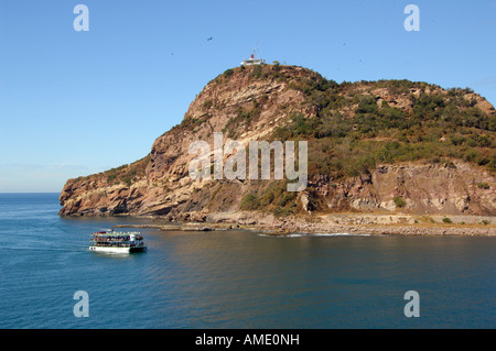 North America, Mexico, State of Sinaloa, Mazatlan. Tourist boat off the coast of El Faro Lighthouse hill. Stock Photo