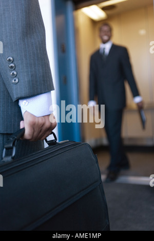 Close up of a Business man holding a briefcase. Stock Photo