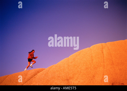 Woman Running Up Hill Stock Photo