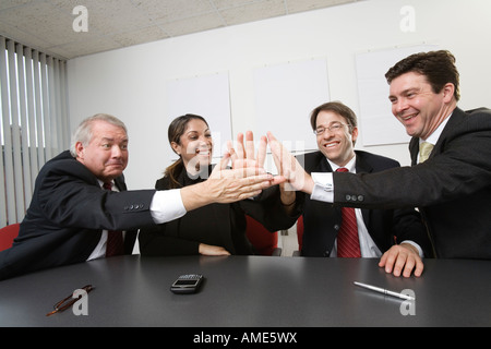 Business colleagues giving a high five. Stock Photo