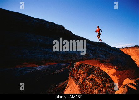 Woman Running Up Hill Stock Photo