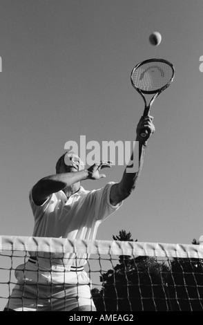 Mature Man Playing Tennis Stock Photo