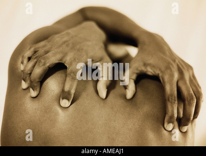 Close-Up of Man's Hands on Back Stock Photo