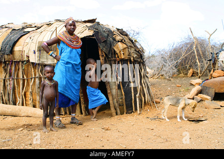 Samburu woman with children and dog in front of her hut, Kenya, Samburu Np Stock Photo