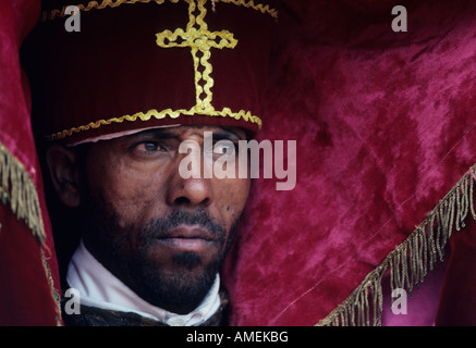 Deacon of the Ethiopian Orthodox Church carrying an ornate processional ...