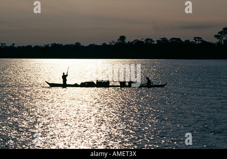 Boat at sunrise on the Brahmaputra river near Dibrugarh, Assam, India, Asia. Stock Photo