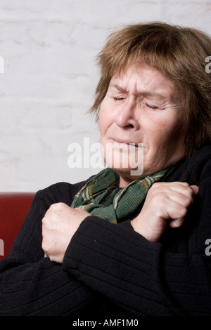 Portrait of a middle aged woman suffering from some kind of pain in the chest Stock Photo