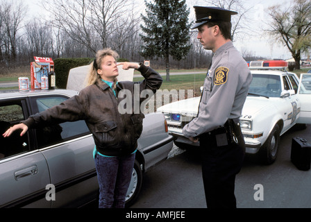 High school teenagers arrested by police for drinking alcohol while driving a car Stock Photo