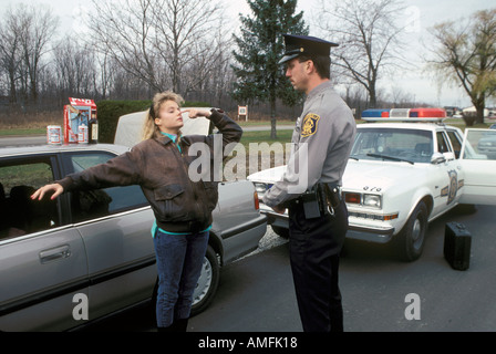 High school teenagers arrested by police for drinking alcohol while driving a car Stock Photo