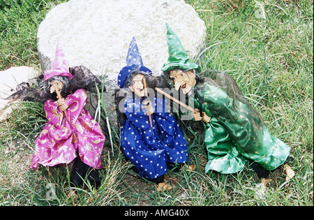 Three colourful witches for sale on display in the grass, Torcello, Venice, Italy Stock Photo