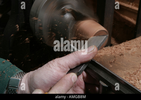Master pipe maker Barry Jones making Briar Pipe by hand in the Wiltshire village of Tileshead Turning the bowl on a lathe Stock Photo