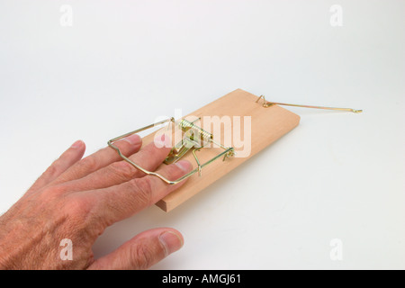 Male hand caught in mouse trap Stock Photo