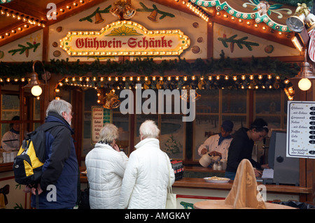people queuing at a gluhwein stall selling mulled wine Berlin Germany Stock Photo