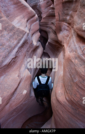Hiker in Peek a Boo slot canyon near Escalante in Grand Staircase National Monument Utah USA Stock Photo