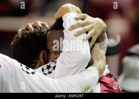 Heads and arms of Sevilla FC players hugging after a goal scoring. Stock Photo