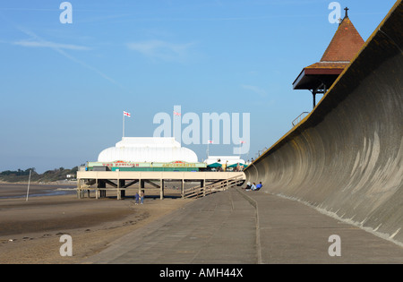 Burnham on Sea Somerset seaside town with reinforced concrete sea defence wave wall and pier Stock Photo