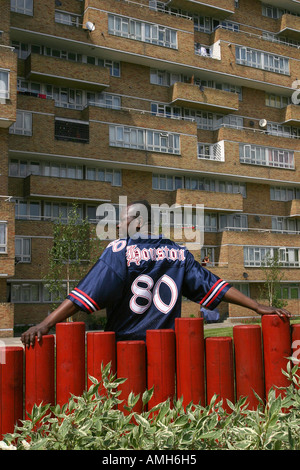 African man standing in front of regenerated housing estate, Forest Hill, London, UK. 2006. Stock Photo