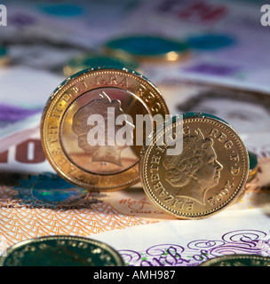 British money. Two pound and one pound coins on sterling bank notes. close up mqcro Stock Photo