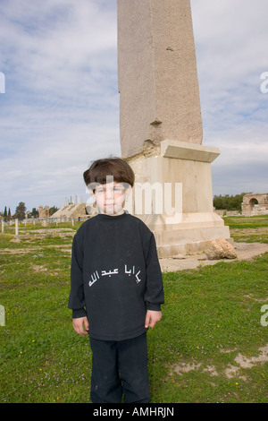 Child near the obelisk that marks the center of the hippodrome in Tyre Lebanon Stock Photo