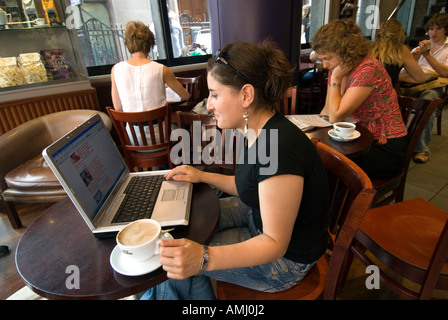 Young woman browsing the internet on a laptop computer in a Caffe Nero, London, England, UK Stock Photo