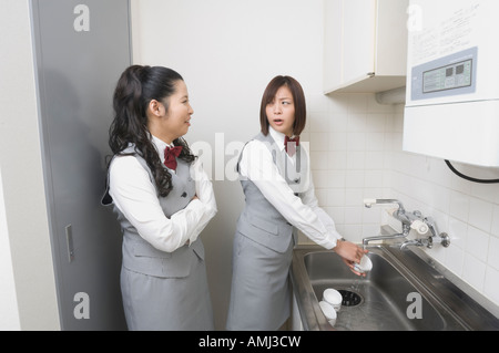 Two office workers talking in kitchen Stock Photo