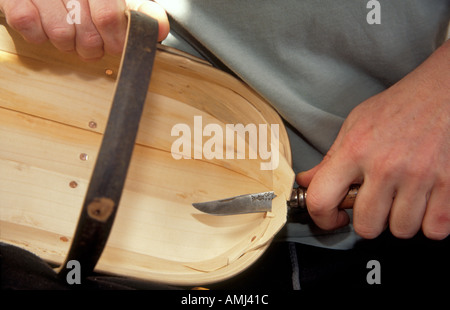 Tim Franks making garden trugs in the traditional way by hand with a trim knife from willow and chestnut wood at Herstmonceux. Stock Photo