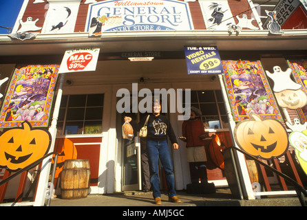 Man on porch of Country Store in Williamstown VT covered with Halloween decorations Stock Photo
