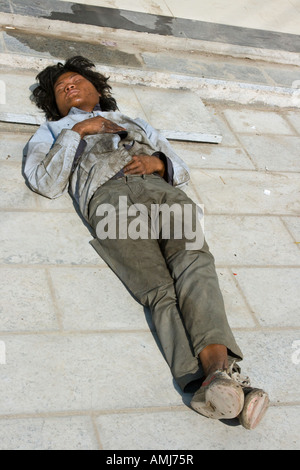Homeless Chinese Man Sleeping on the Street, Yangshuo CHina Stock Photo