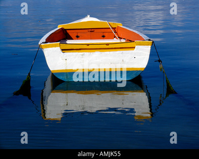 Brightly coloured rowing boat and reflection Philipsburg Dutch Sint Maarten Stock Photo