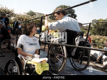 Two speakers at a national disability civil rights event, talking through the rails of the wheelchair ramp Stock Photo