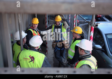 Migrant construction workers from Lithuania in discussion on a building site, London, UK. Stock Photo