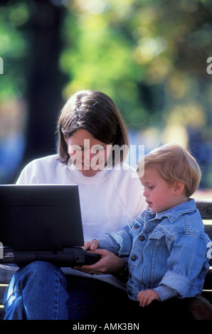 Mother and son using laptop in a park Stock Photo