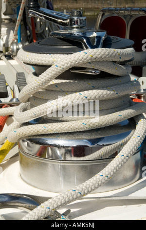 Closeup of nylon ropes securely wrapped around the capstan of the Alba Explorer sailing yacht in the harbour of Dundee UK Stock Photo