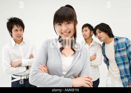 A young woman standing with arm crossed Stock Photo