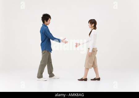 Two young people extending handshake Stock Photo