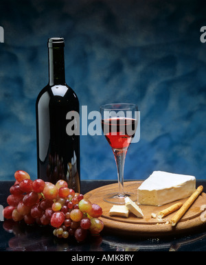 Still life with red wine, red grapes and cheese, studio shot Stock Photo