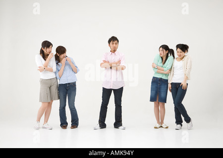 Young man standing among four women Stock Photo