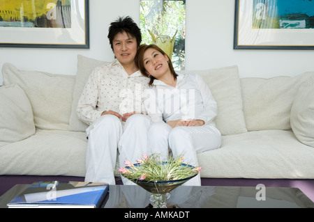 Couple sitting on sofa Stock Photo