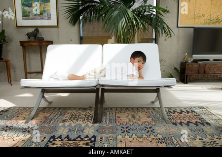 Boy lying on sofa Stock Photo