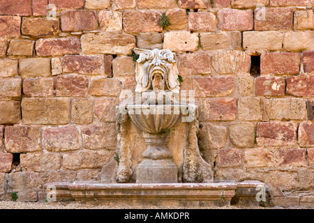 Fountain in stone wall in the courtyard of Fontfroide, France Stock Photo
