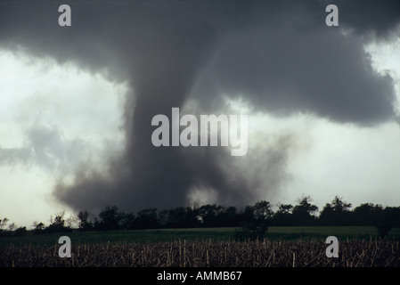 A close tornado forms beneath the wall cloud of a supercell ...