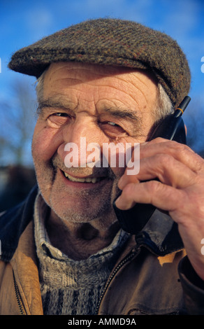 Elderly man using mobile phone Stock Photo