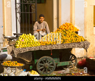 Fruit seller with his barrow of oranges and lemons at the market in back streets of Luxor Egypt Stock Photo